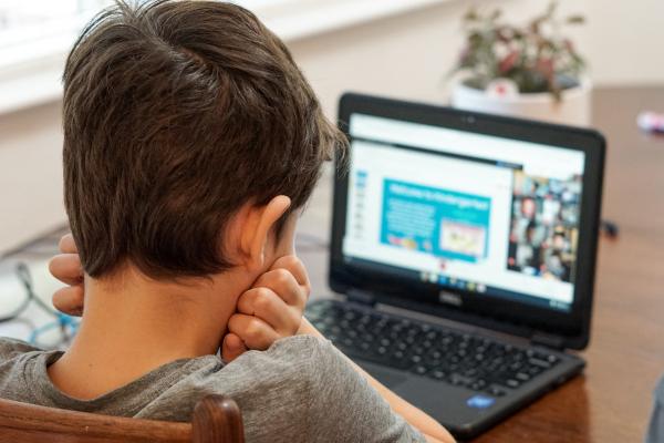 boy at laptop attending school